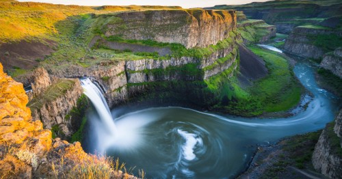 Looking down at Palouse Falls, the tallest waterfall in Washington, as it tumbles into a large natural pool below.