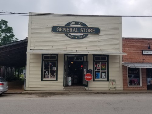 A historic general store in Gruene, Texas, featuring a classic sign and large windows.