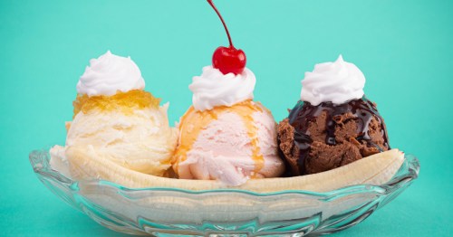 A banana split on a teal background.