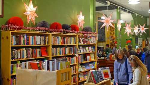 A cozy bookstore with colorful star decorations, shelves filled with books, and customers browsing.