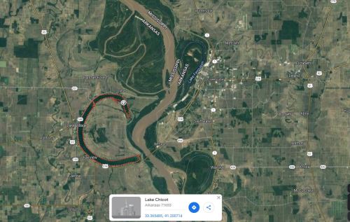 Aerial view of Lake Chicot and surrounding landscape, featuring winding waterways and nearby towns.