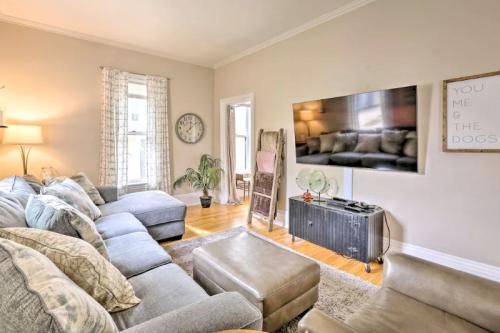 Cozy living room with a gray sectional sofa, a TV on the wall, and a decorative ladder against the wall.