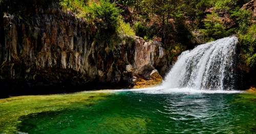 fossil creek waterfall cascades into an emerald pool below in camp verde arizona