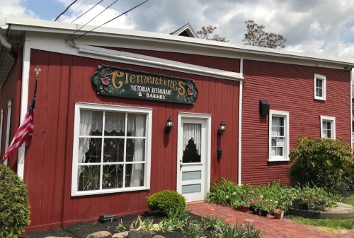 A charming red building with a sign reading "Glenmartin's Victorian Restaurant & Bakery," featuring a white door and window.