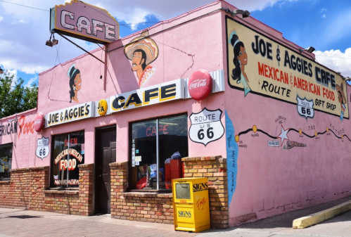Colorful exterior of Joe & Aggie's Cafe, featuring Route 66 signage and murals, serving Mexican and American food.