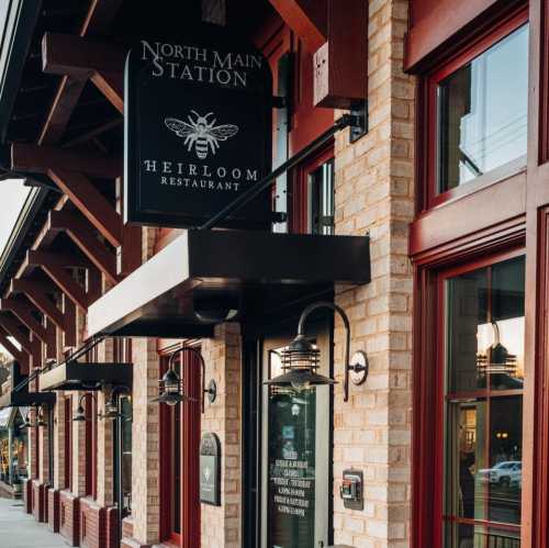 Exterior view of Heirloom Restaurant at North Main Station, featuring a sign and decorative lanterns.