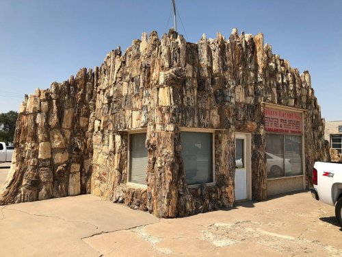 A unique building with a rocky, textured exterior resembling natural stone formations.