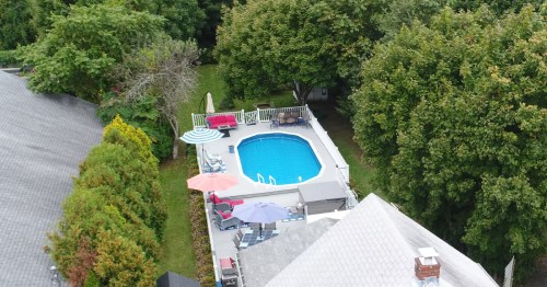 aerial shot of a cottage backyard with a pool and outdoor seating in jamestown rhode island