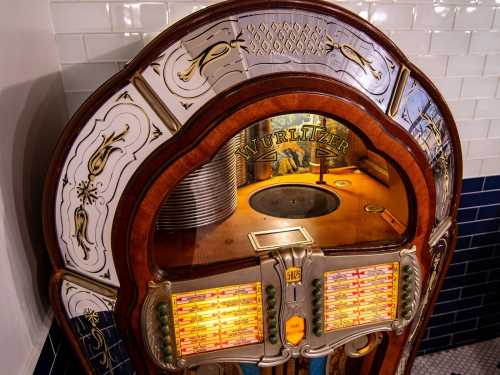 A vintage Wurlitzer jukebox with ornate design and colorful song selection buttons.