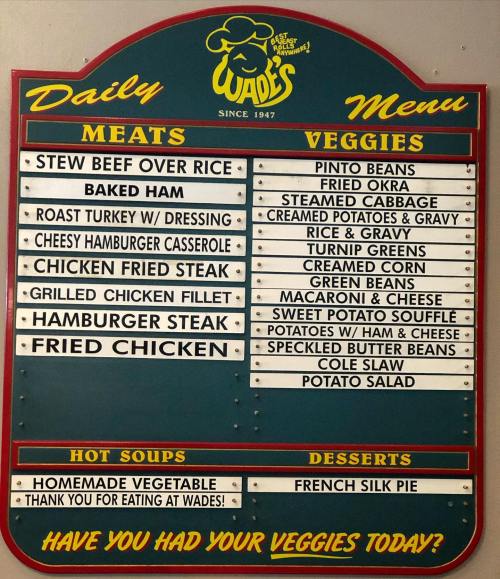 Menu board featuring daily specials: meats, veggies, hot soups, and desserts at Wade's since 1947.