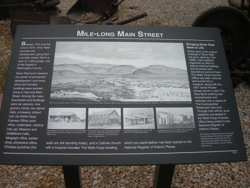 Sign detailing the history of Silver Reef, Utah, with images and text about its development and significance.