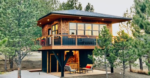 a modern treehouse with a covered porch in custer south dakota