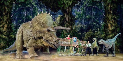 A large triceratops and two smaller dinosaurs are featured in a jungle setting, with people holding a sign that reads "Adventure Zone."