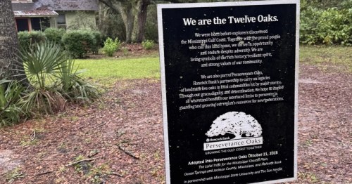a black sign that says "We are the Twelve Oaks."