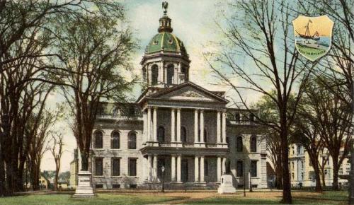 Historic building with a green dome, surrounded by trees, featuring a coat of arms in the corner.