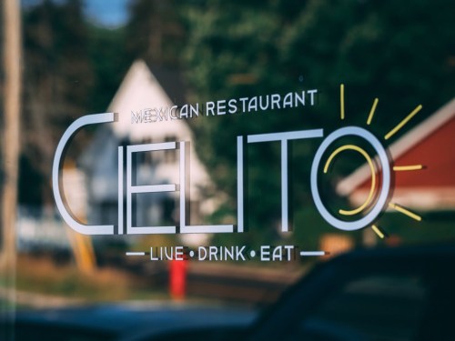Sign for "Celito" Mexican restaurant with the tagline "Live Drink Eat" displayed on a window.