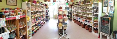 A colorful candy shop interior with shelves filled with various candies and treats, creating a vibrant atmosphere.