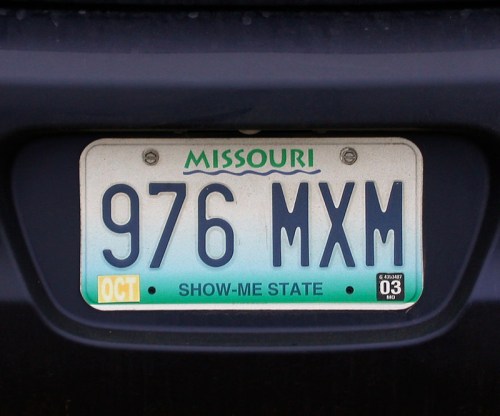 Missouri license plate with the number 976 MXM, labeled "SHOW-ME STATE" and dated October.