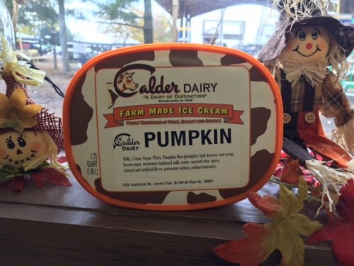Container of Calder Dairy pumpkin ice cream, featuring a cow design and a label with product details.