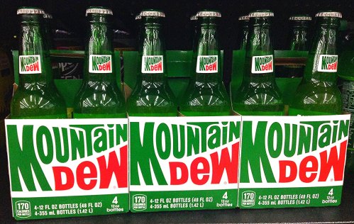 Six green bottles of Mountain Dew in a display, each pack containing four 12-ounce bottles.