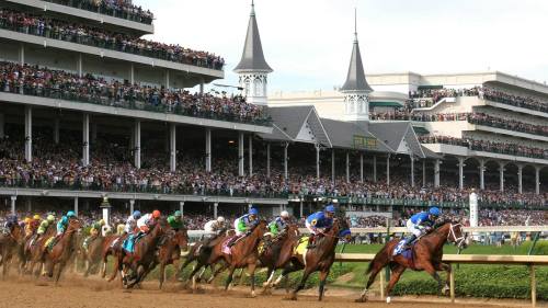A thrilling horse race at a packed racetrack, with horses and jockeys in colorful silks racing towards the finish line.