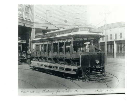 Black and white photo of a streetcar labeled "Public Service" with a conductor at the front, dated September 18, 1897.