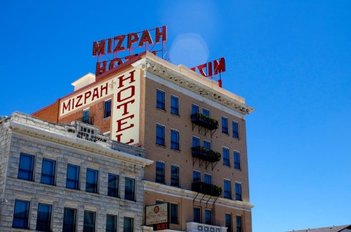 Historic Mizpah Hotel building with red signage against a clear blue sky.