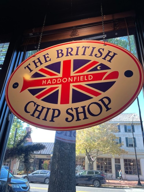 Sign for "The British Chip Shop" in Haddonfield, featuring a Union Jack design and a fish graphic.