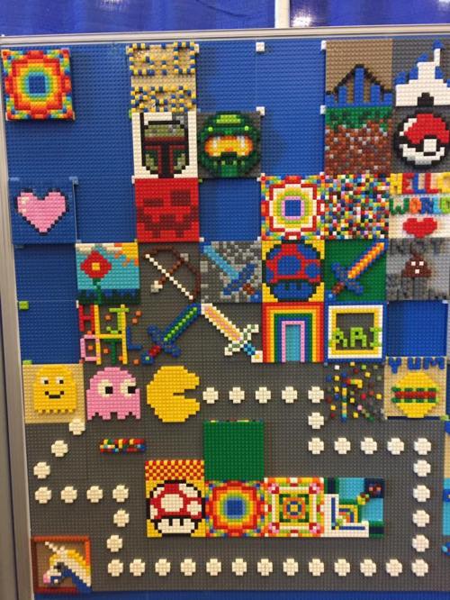 Colorful mosaic made of LEGO bricks featuring various designs, including characters, symbols, and patterns.