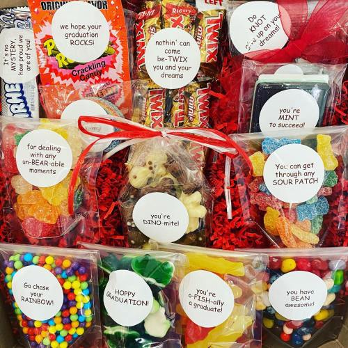 A colorful gift box filled with candy and playful messages celebrating graduation and achievements.