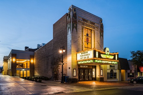 Historic Egyptian theater at dusk, featuring a marquee for a horror film series, surrounded by charming architecture.