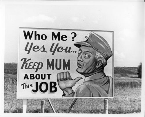 A vintage sign featuring a man in a cap, urging viewers to keep quiet about a job opportunity.