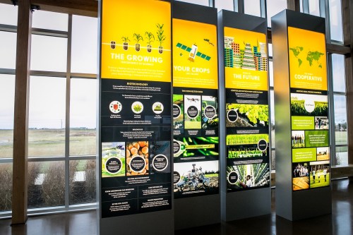 Informational displays about agriculture, biotechnology, and sustainable practices in a modern exhibit space.