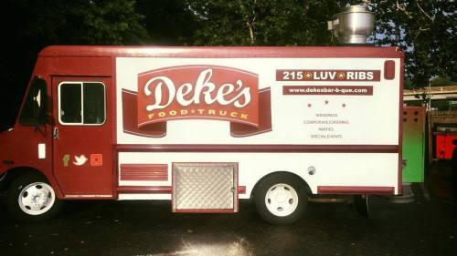 A food truck named "Deke's" featuring a red and white design, promoting BBQ catering for events and special occasions.
