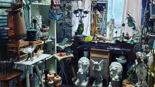 A cozy shop filled with various antiques, decor items, and sculptures, including lions and birds.