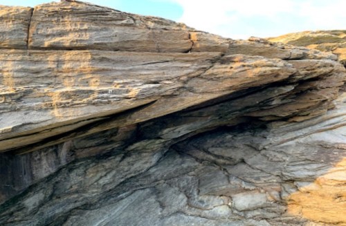 Close-up of layered rock formations with textured surfaces and natural lighting.