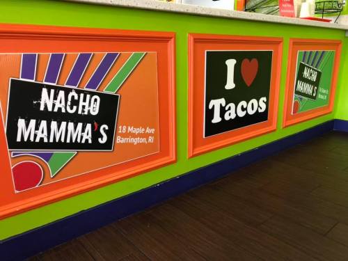 Colorful wall signage for Nacho Mamma's, featuring "I Love Tacos" and the address in Barrington, RI.