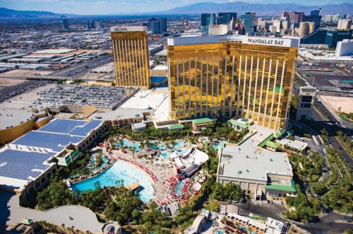 Aerial view of Mandalay Bay and Delano hotels in Las Vegas, featuring a pool area and city skyline in the background.