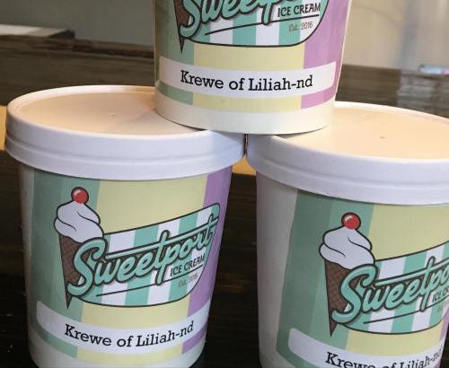 Three ice cream containers from Sweetport Ice Cream, labeled "Krewe of Liliah-nd," with colorful designs.