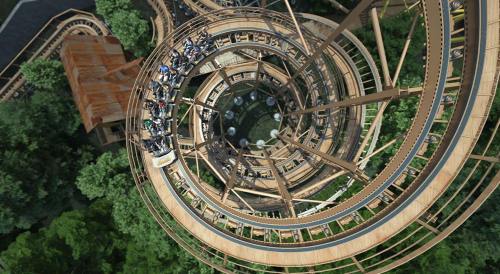 Aerial view of a wooden roller coaster spiraling down through a lush green forest.