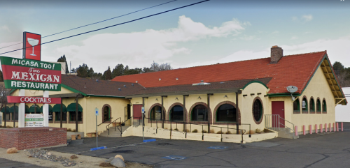 Exterior of Micasa Too Mexican Restaurant, featuring a red roof, arched windows, and a large sign.
