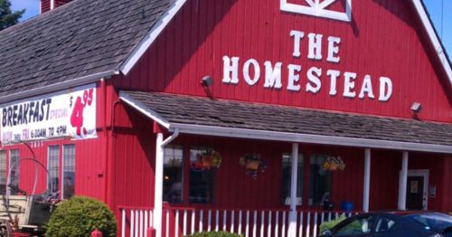 A red barn-style building with the sign "The Homestead" and a breakfast special banner.