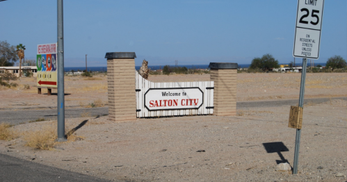 Welcome sign for Salton City, with a clear blue sky and desert landscape in the background.