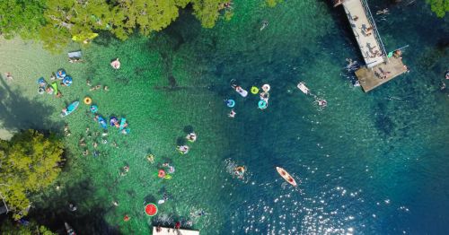 Aerial view of people floating in a Florida natural spring in the summer