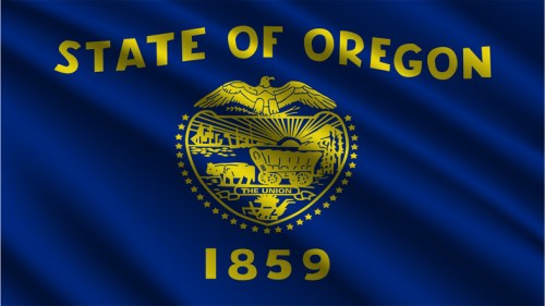 Oregon state flag featuring an eagle, a shield with a wagon, and the year 1859 on a blue background.