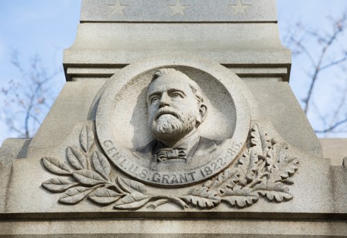 Close-up of a stone monument featuring a relief of Ulysses S. Grant, with his name and dates inscribed below.
