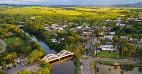 The historic Rainbow Bridge over a river, leading into the charming town of Haleʻiwa.