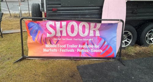 A colorful banner for "SHOOK" mobile food trailer, promoting services for markets, festivals, parties, and events.