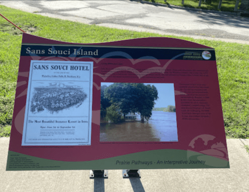 Sign about Sans Souci Island featuring a historic hotel image and a photo of a flooded area.