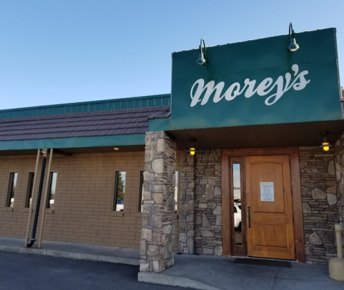 Exterior of Morey's restaurant featuring a stone facade and a green sign with the name "Morey's" above the entrance.